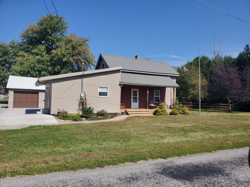 a small house with a yard and a road in front of it