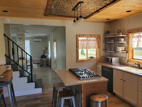 the kitchen is open to the living room and dining room
