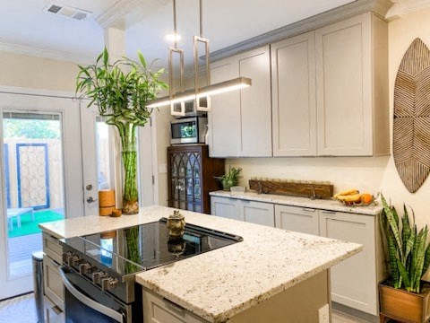 a kitchen with white cabinets and a marble counter top