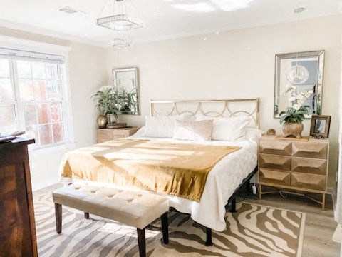 a bedroom with a bed with a gold blanket on it