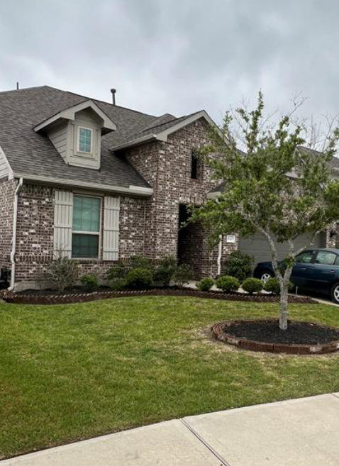 A house with a tree in front of it.