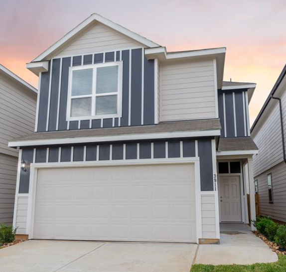 A two-story house with a garage door.