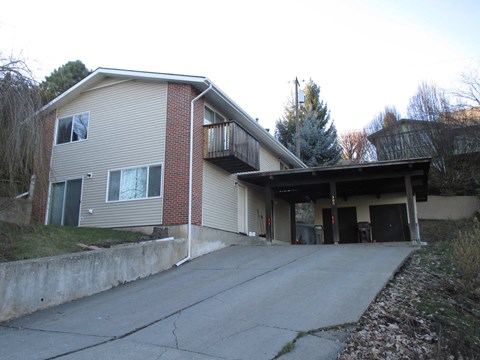 the front of a house with a driveway and a garage door