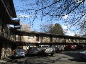 a parking lot with cars parked in front of a building