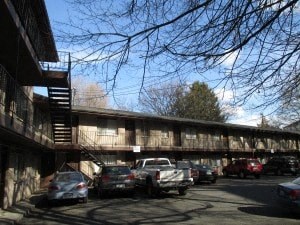 a parking lot with cars parked in front of a building