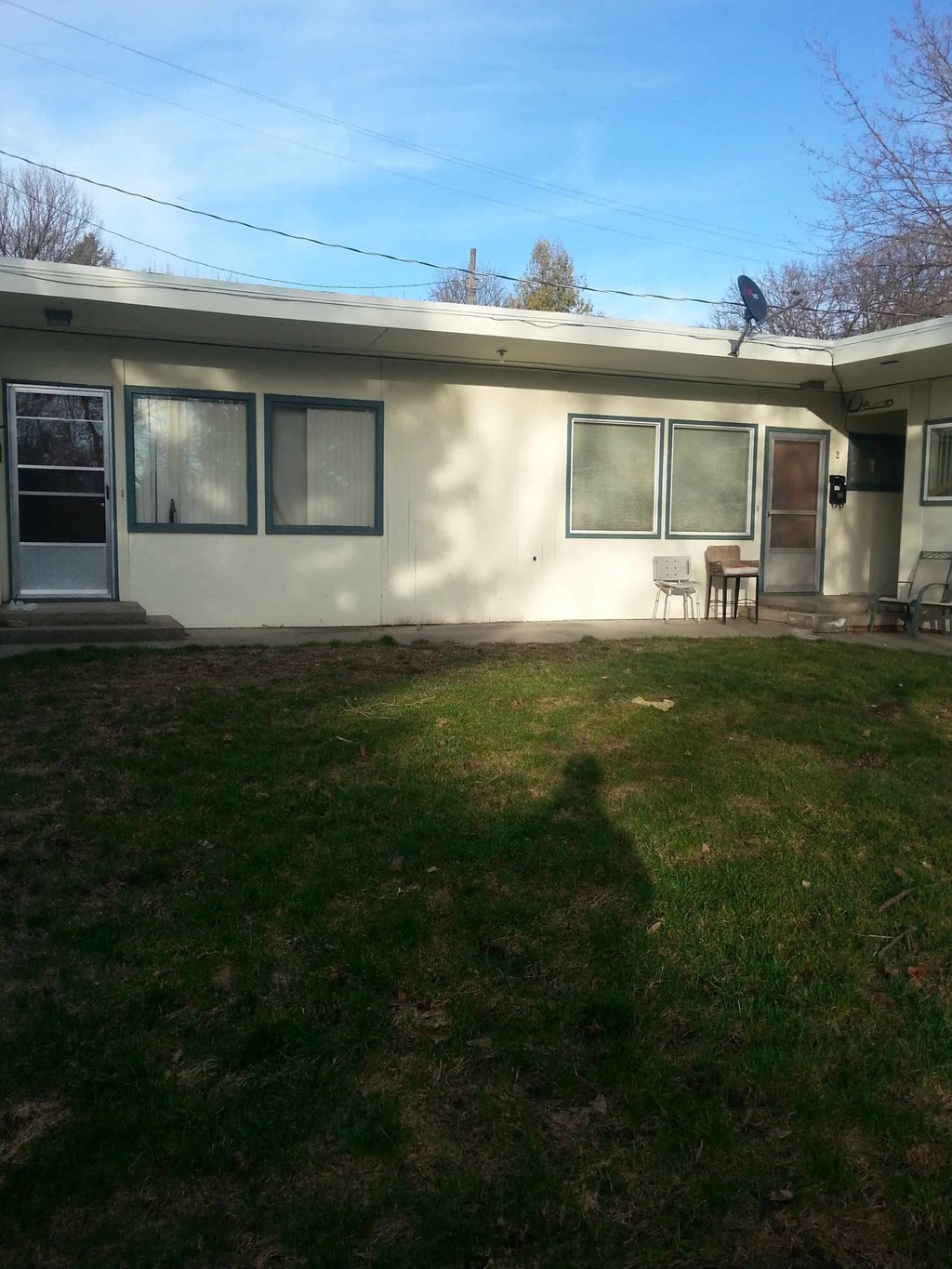 a remodeled house with a yard in front of it