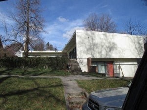 a white building with a car parked in front of it