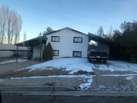 a white house with a truck parked in front of it
