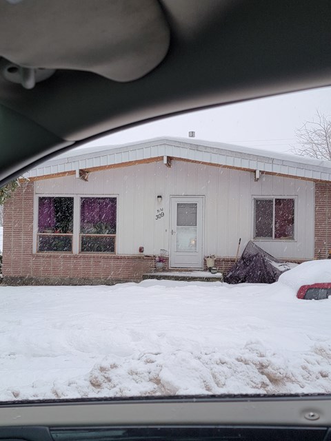 a house in the snow from a car window