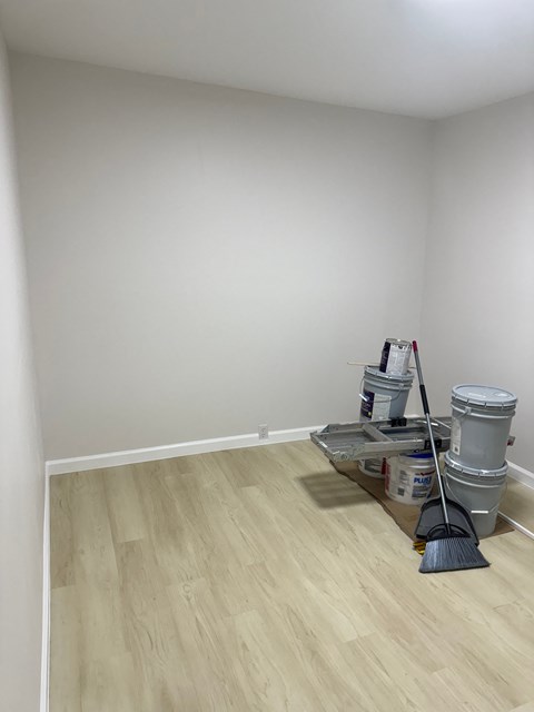 the living room is being remodeled with white walls and wood floors