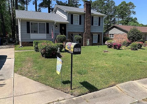 a mailbox in the front yard of a house