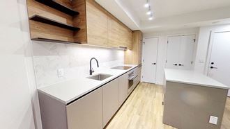 a kitchen with white counter tops and a sink