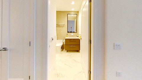 a view of a bathroom from the doorway of a hotel room