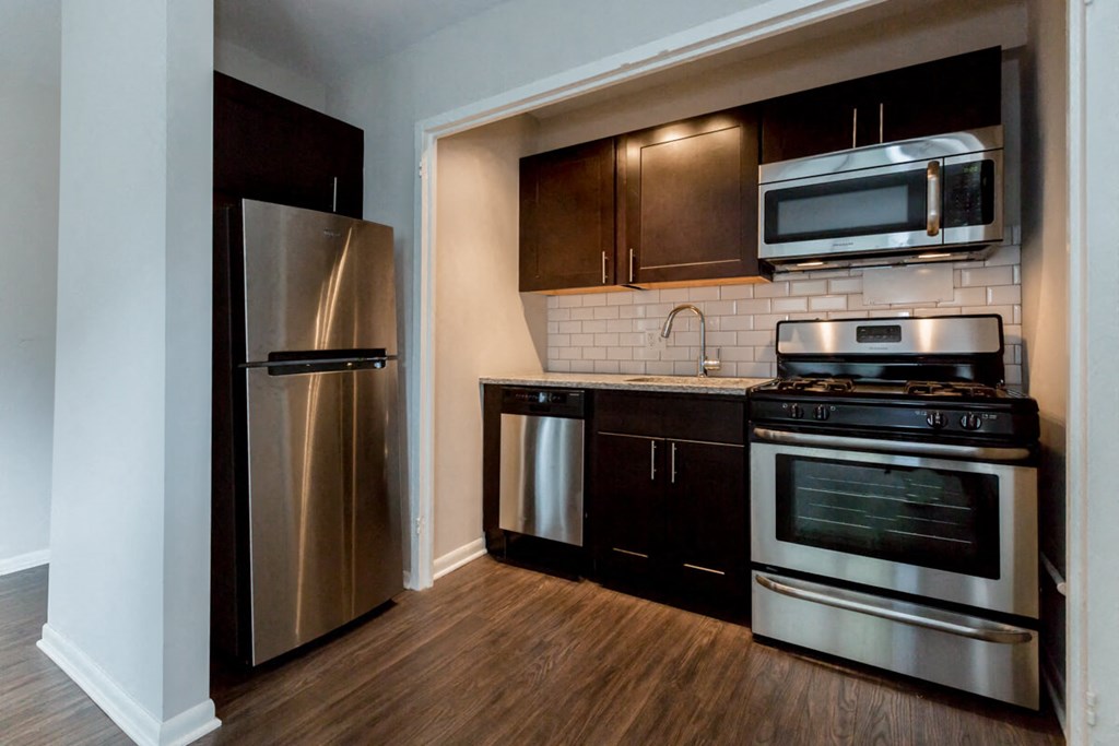 a kitchen with stainless steel appliances and a stainless steel refrigerator