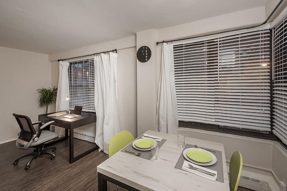 a dining room with a table and chairs and a window