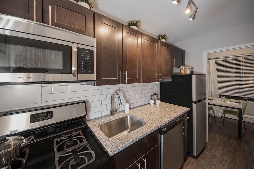 a kitchen with stainless steel appliances and a granite counter top