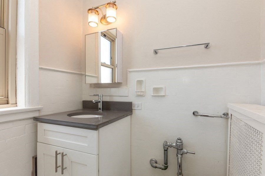 a small bathroom with a sink and a mirror