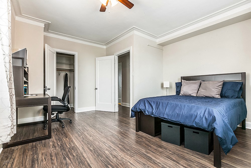 a bedroom with a bed and a desk and a chair