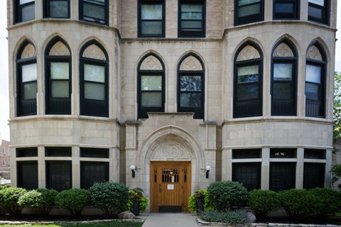 the front of a building with a wooden door