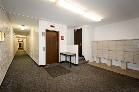 the hallway of a locker room in a gym with lockers and a table