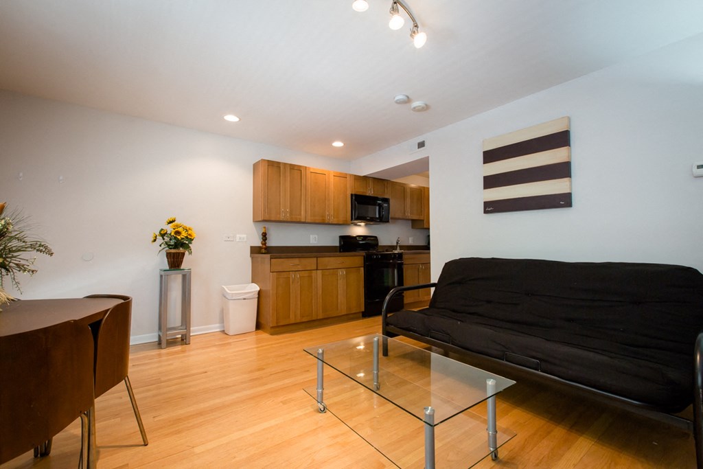 a living room with a couch and a kitchen