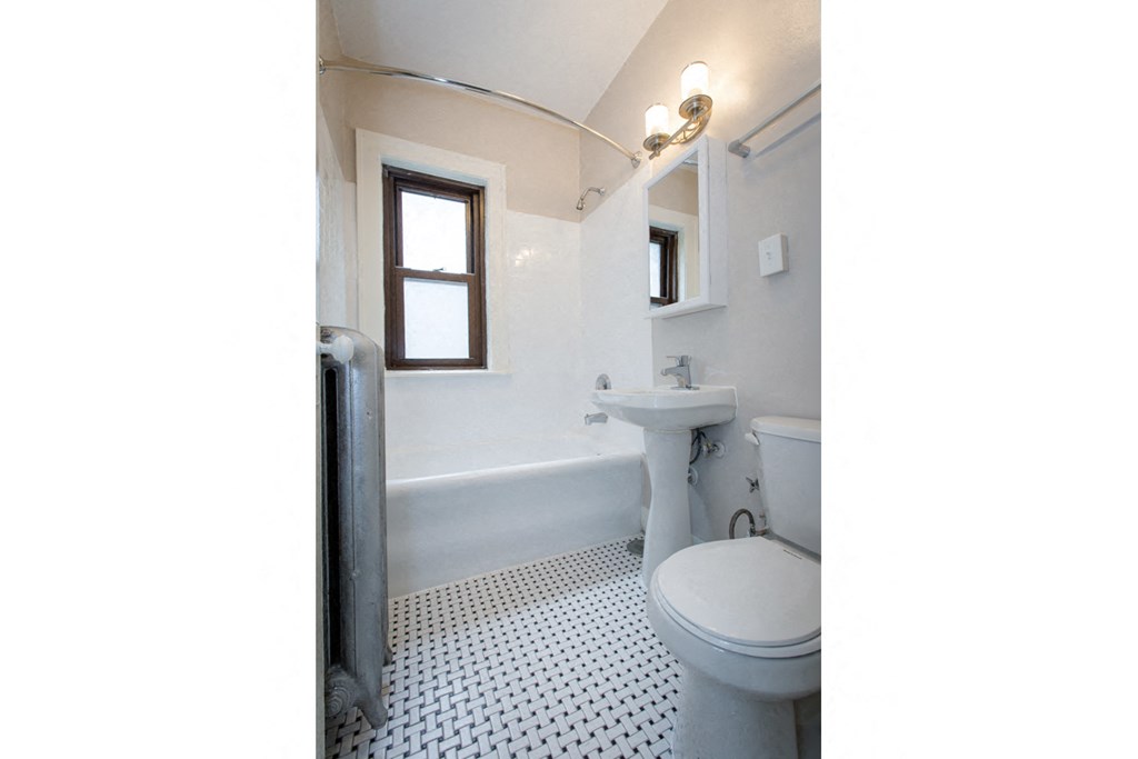 a white bathroom with a toilet and a sink