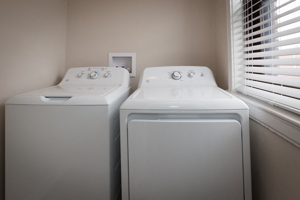 two washers and dryers in the laundry room of a home