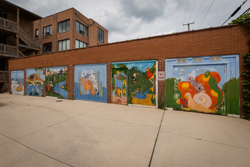 a row of murals on the side of a brick building