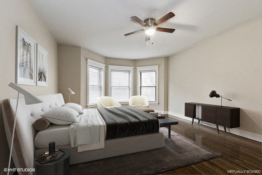 a bedroom with a bed and a ceiling fan