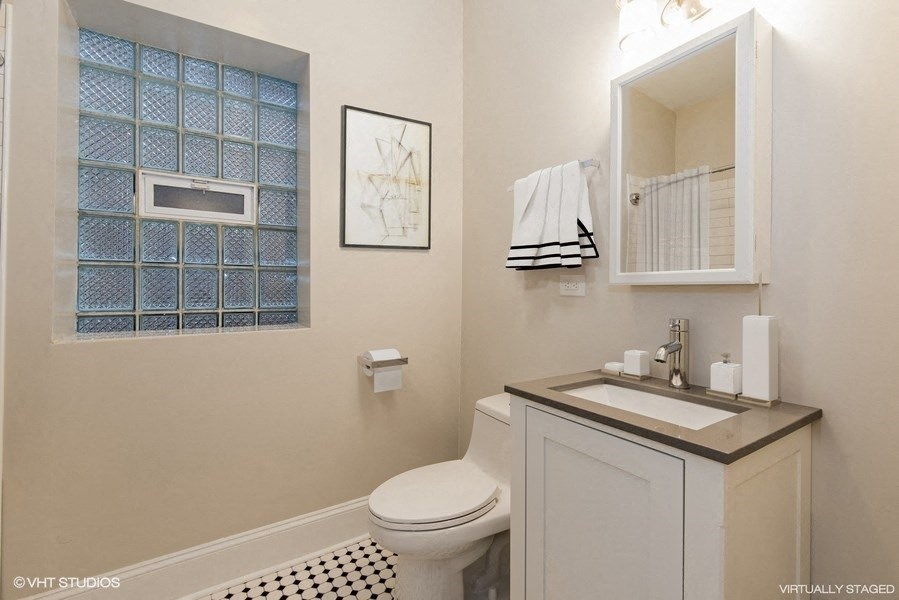 a bathroom with a toilet sink and a mirror