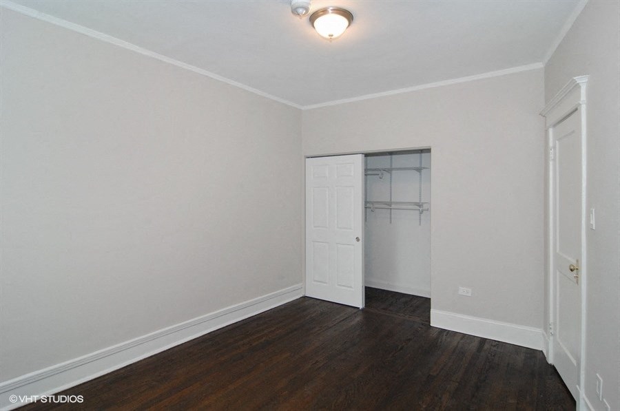 the living room of an empty house with white walls and a closet