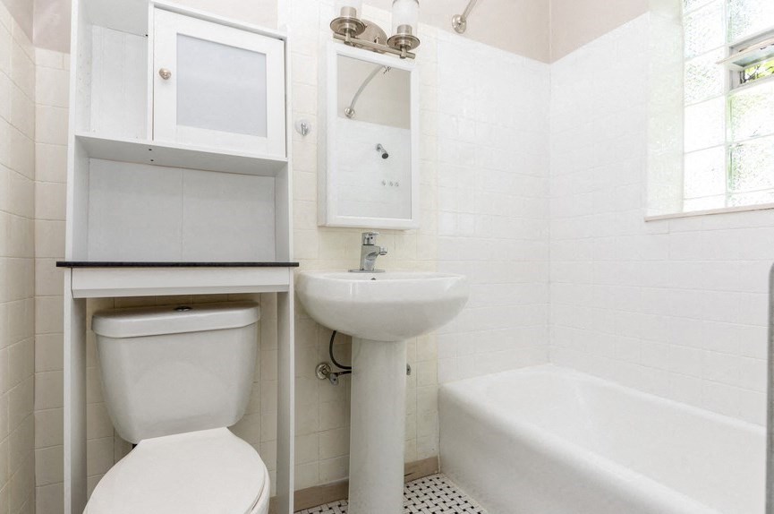 a small bathroom with a sink toilet and a tub