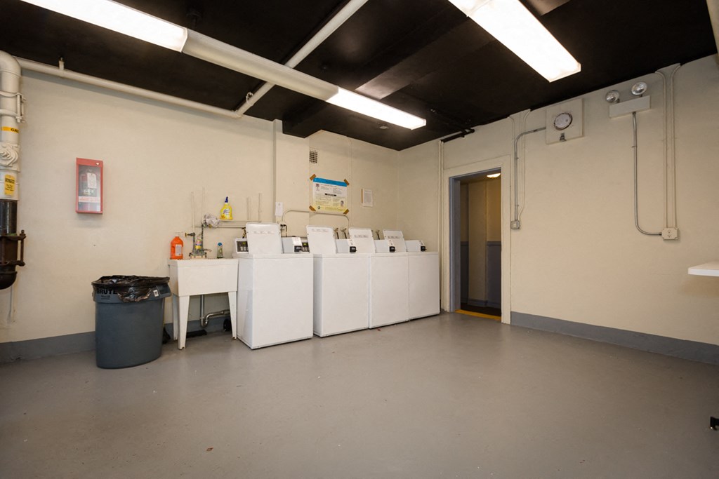 a laundry room with several washing machines in it