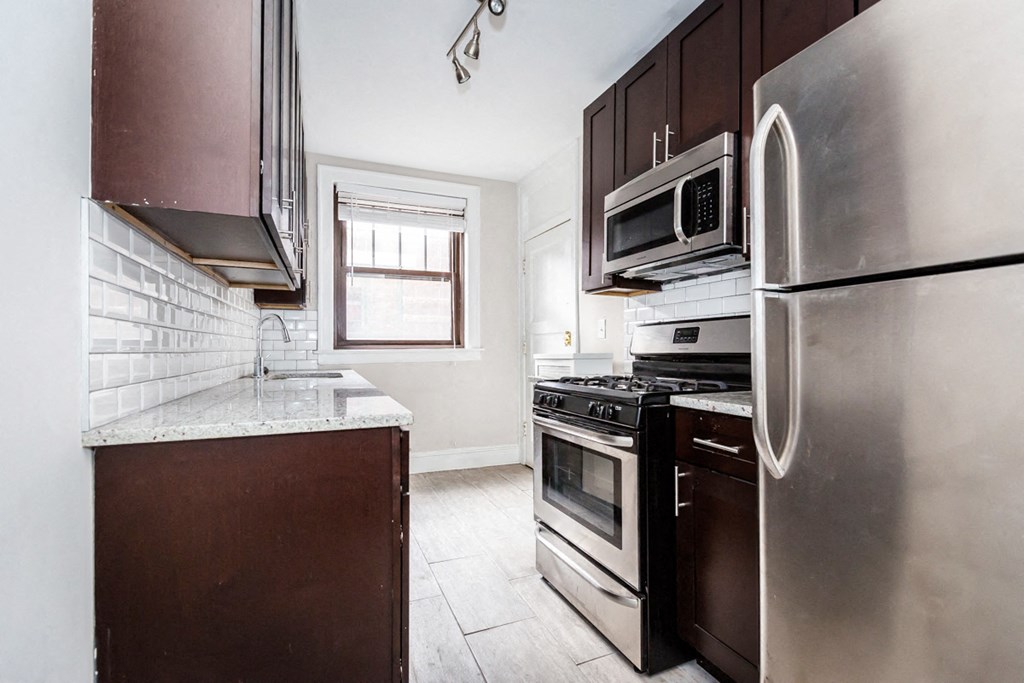 a kitchen with stainless steel appliances and a counter top
