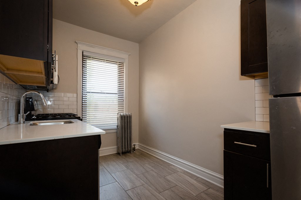 an empty kitchen with a sink and a window