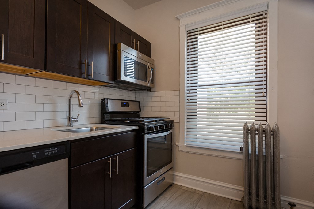 a kitchen with a sink and a stove and a window