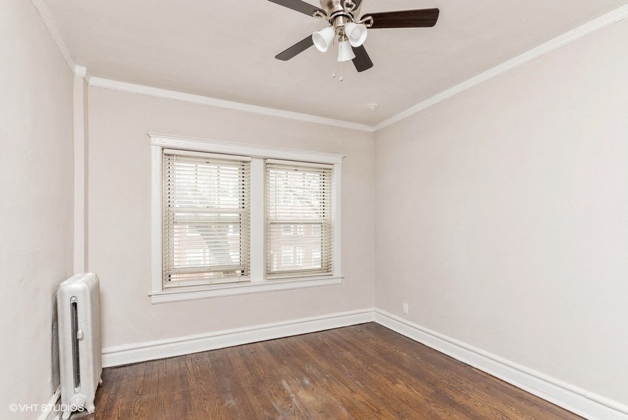 an empty room with a ceiling fan and a window