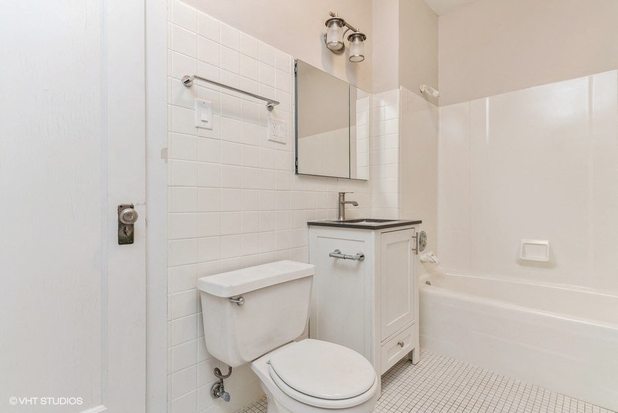 a white bathroom with a white toilet and a sink