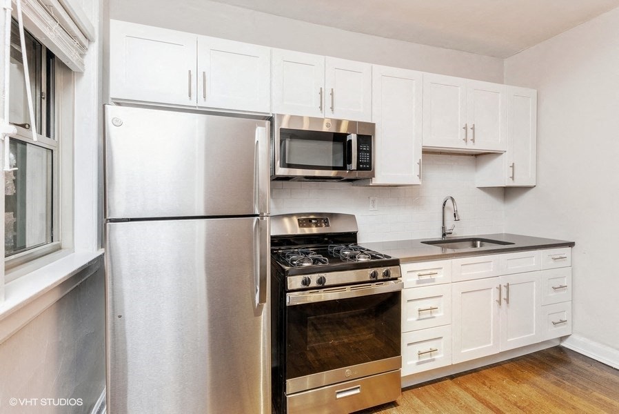 a kitchen with stainless steel appliances and white cabinets