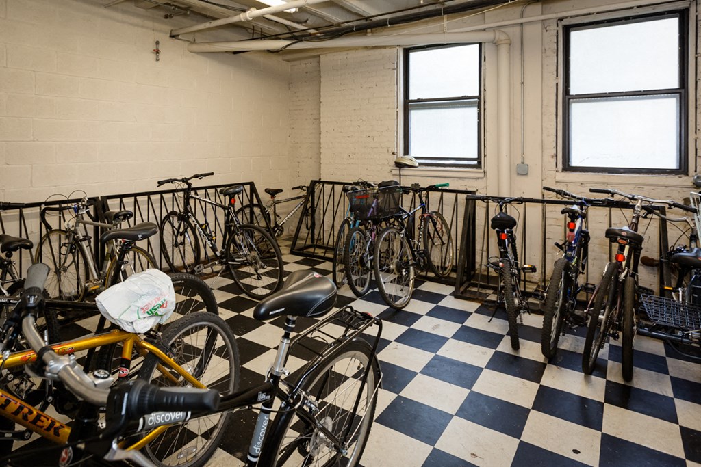 a group of bikes parked in a room with checkered floors