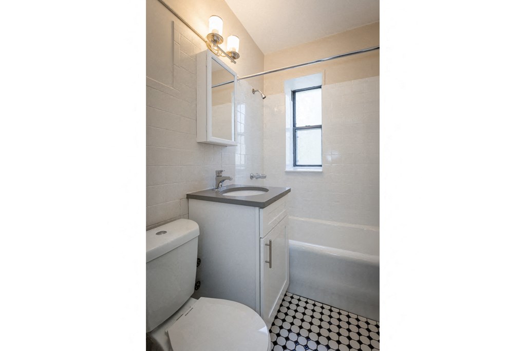 a white bathroom with a toilet and a sink