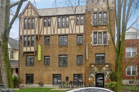 a large brick building with a car in front of it