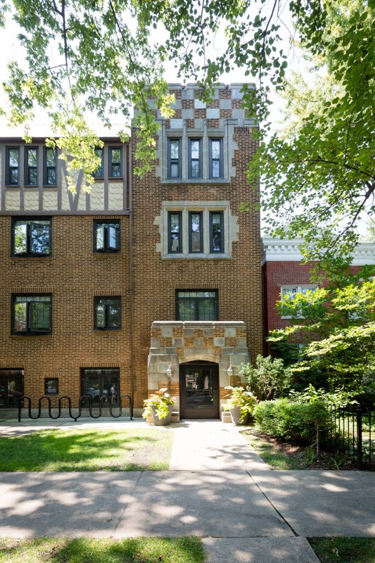 a large brick building with a sidewalk in front of it