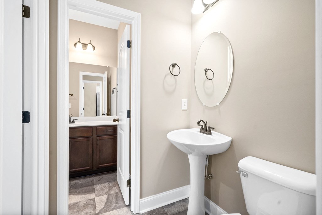 a bathroom with a sink and toilet and a mirror