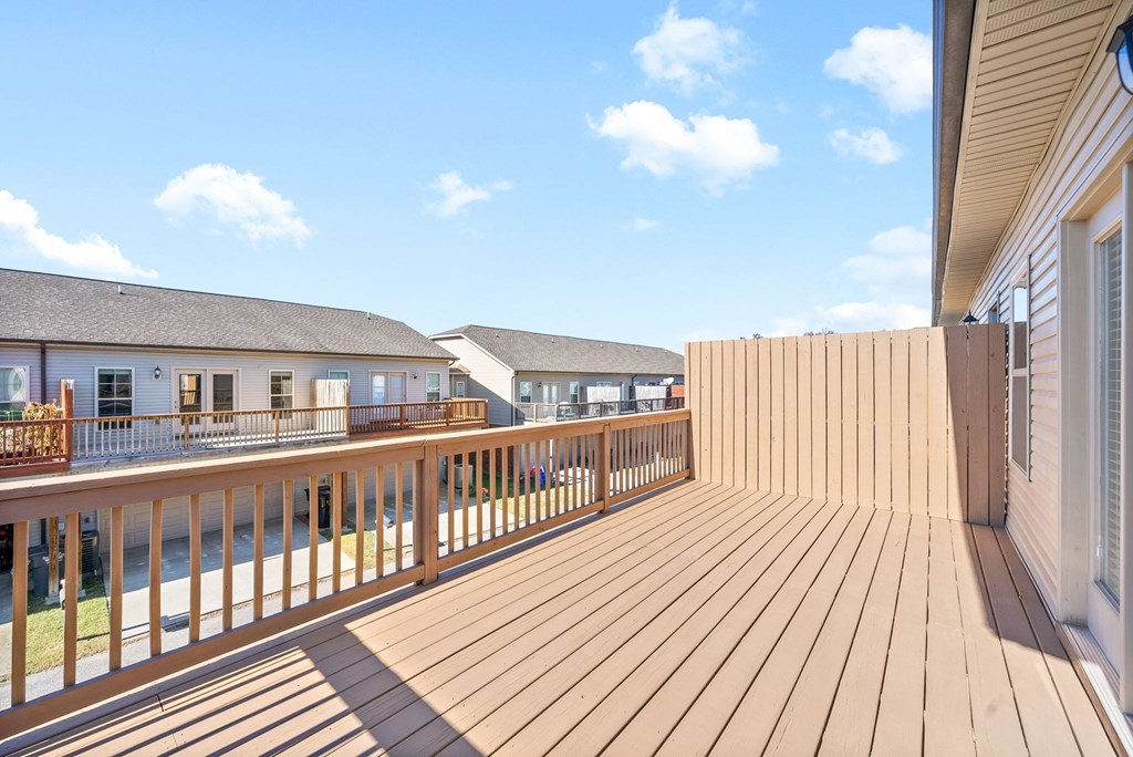 a view of a balcony with a wooden fence