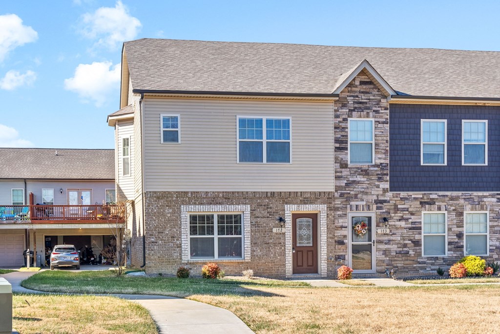 a large house with a sidewalk in front of it