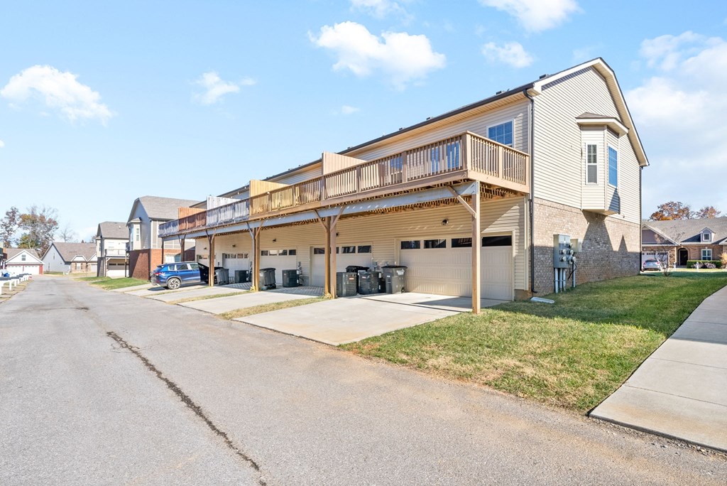 the front of a house with a garage and a porch on a street
