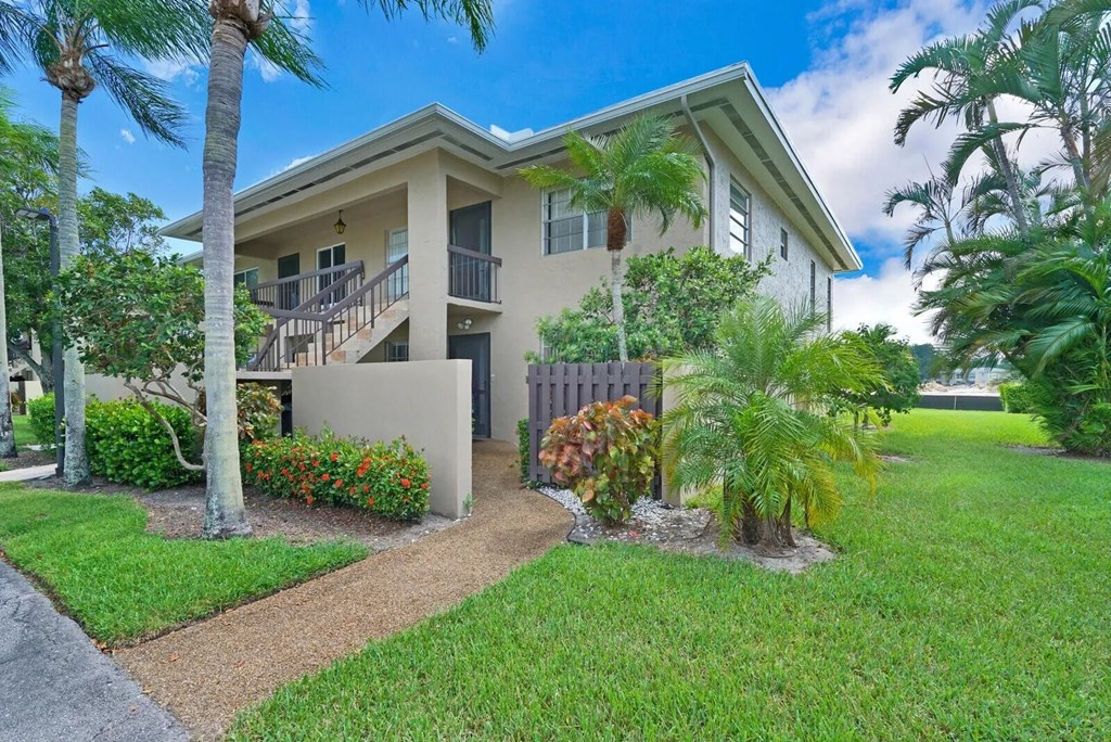 a house with palm trees in front of it