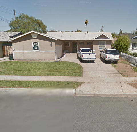 a house with two cars parked in front of it
