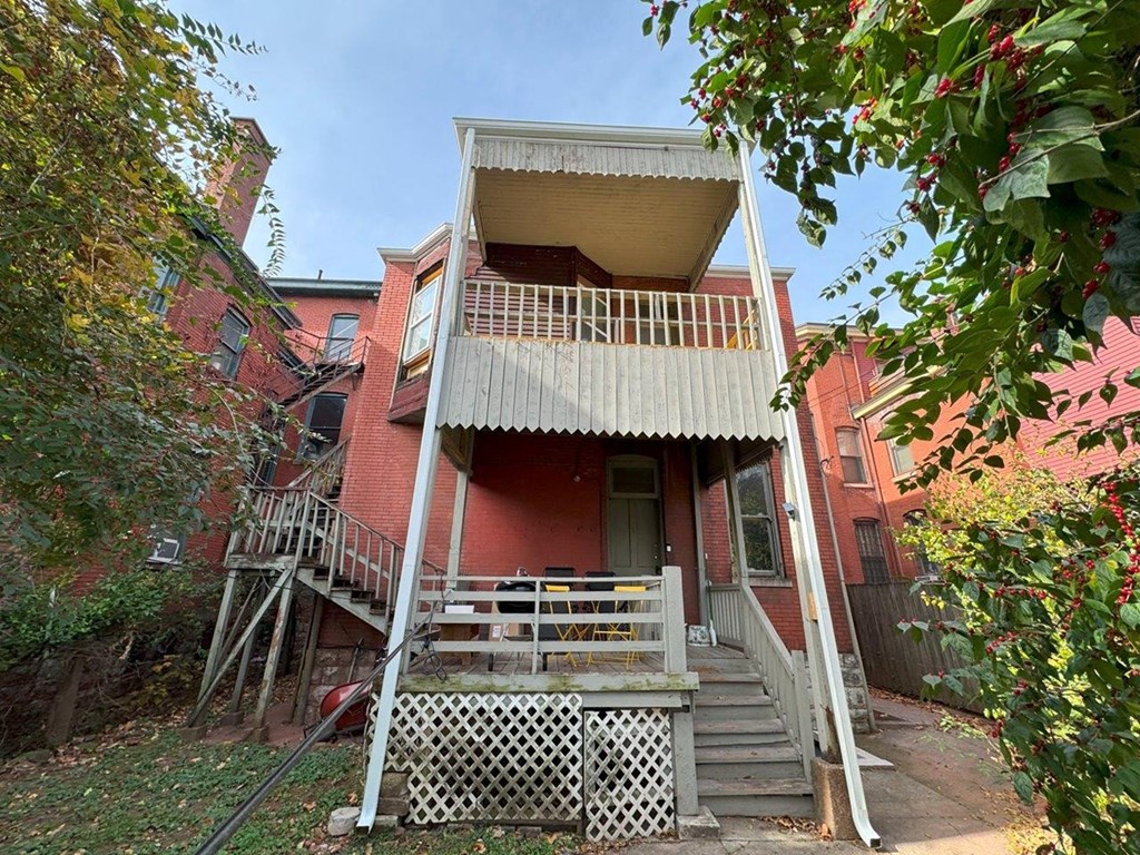 an old with a balcony and stairs